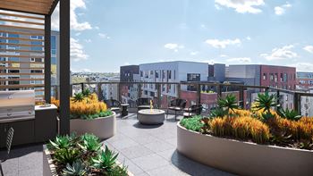 a rooftop terrace with a view of the city